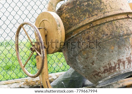 Old rusty yellow cement mixer