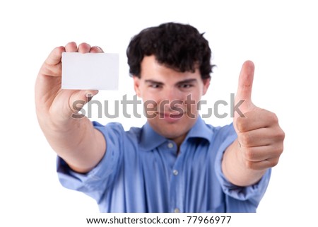 Young businessman with thumb raised as a sign of success, and a blank business card in hand, isolated on white background. studio shot