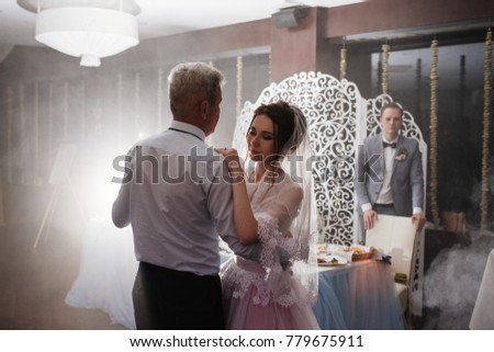 Wedding banquet. The bride is dancing with dad in a restaurant.