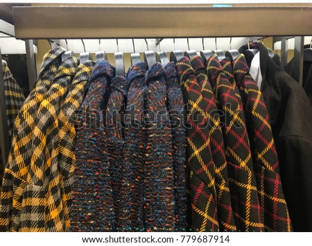 Men's different colorful coat,jacket on hangers in the store
