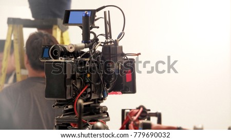 Behind the 4k high defination video camera shooting by film crew team in big studio production.