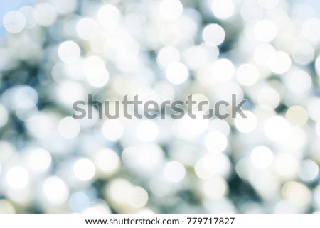 Beautiful luxury bokeh background with white circles over blue, yellow and green. Christmas, new year concept. Text space