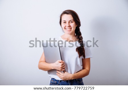 cheerful young woman stand with laptop with white background