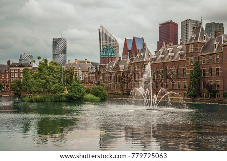 Hofvijver lake with the Binnenhof (Gothic government buildings) and skyscrapers in The Hague. Important political center is a mix of historic city with modernity. Western Netherlands.
