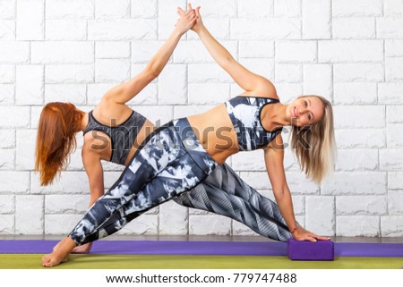 two girls doing yoga exercises
