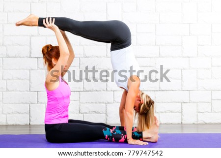 two girls doing yoga exercises