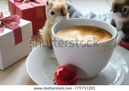 Two Cute squirrels are playing near coffee cup with background christmas 's gift.Christmas theme.