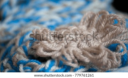 Close up colorful yarn texture background, beige, brown and blue strains. Shallow depth of focus. Knitting and crochet, craft work concept. Winter clothes. Color combination for styling.