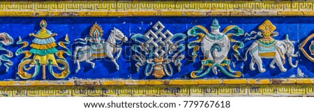 Bright colorful relief on the stupa, a symbol of Tibetan Buddhism