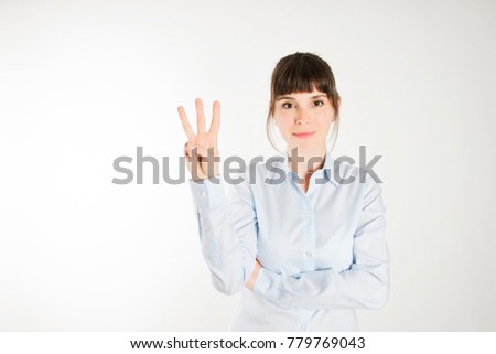 A young woman making 3 sign with her hand
