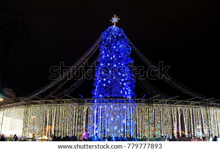 View on beautiful decorated blue Christmas tree with bright lights outdoors at night in Kyiv, Ukraine, 2018.