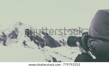 Outdoor photographer in winter mountains