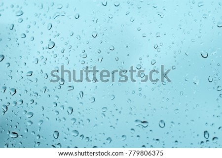 Water drops on glass textured dark background blue