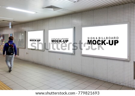Three mock up the white screen billboard in subway station for advertising, information or media on wall of corridor, blur passenger walking through the left
