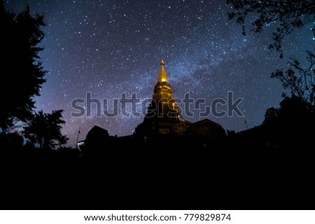 Thai ancient temples, mountains, stars and the Milky Way in the beautiful night sky.