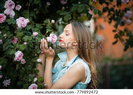 Beautiful card, feminine woman inhales aroma, holding roses, bushes flowers, nature, outdoor, summer