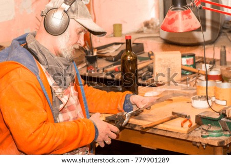 Craftsman working in his workshop, making wooden souvenirs