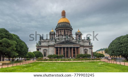 St. Isaac Cathedral timelapse hyperlapse in Saint-Petersburg, Russia. Sityscape with cloudy sky and green lawn