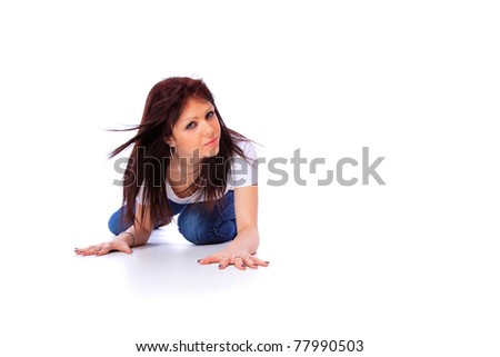 smiling young woman in jeans and t shirt, studio shot over white background