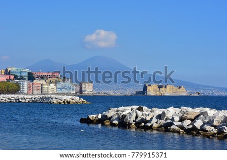 Italy, Naples, cliff of Via Caracciolo with Castel dell'Ovo and Mount Vesuvius in the background. Royalty-Free Stock Photo #779915371