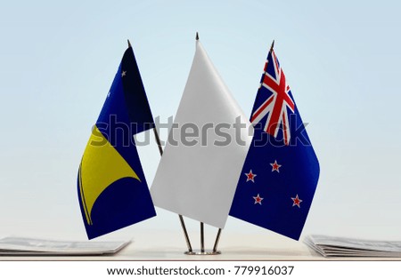 Flags of Tokelau and New Zealand with a white flag in the middle