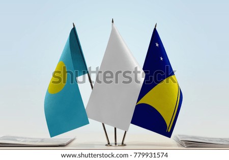 Flags of Palau and Tokelau with a white flag in the middle