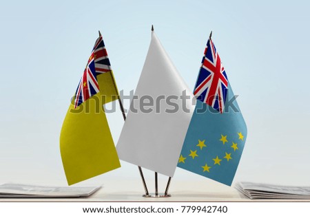 Flags of Niue and Tuvalu with a white flag in the middle