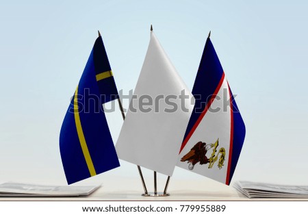 Flags of Nauru and American Samoa with a white flag in the middle
