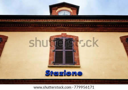 Italian historic train station with the word Stazione (station) written on the facade