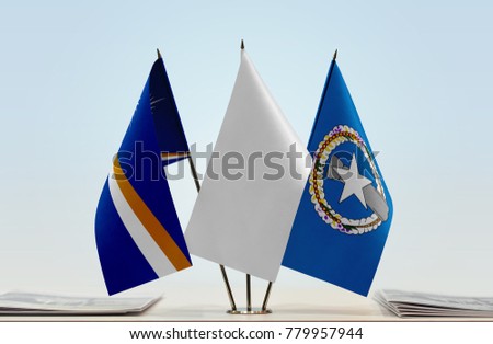 Flags of Marshall Islands and Northern Mariana Islands  with a white flag in the middle