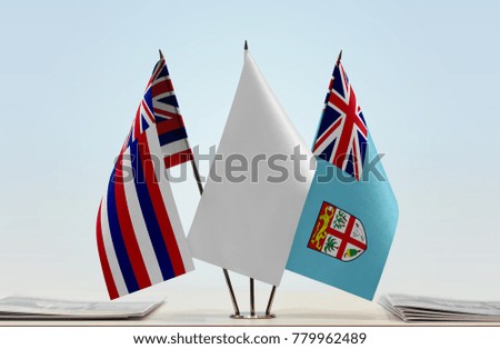 Flags of Hawaii and Fiji with a white flag in the middle