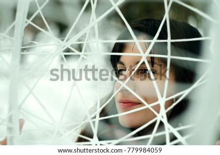 Portrait of a young girl on white threads in winter