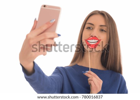 Beauty funny teenage girl with paper mouth on stick making selfie with her cellphone