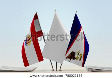 Flags of French Polynesia and American Samoa with a white flag in the middle