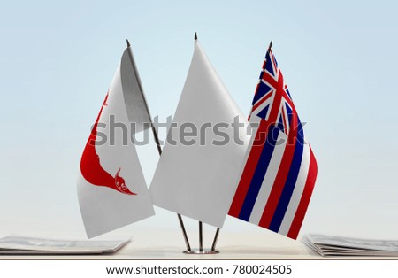 Flags of Easter Island and Hawaii with a white flag in the middle