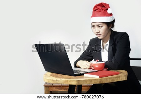 Christmas Business Woman are seriously looking at the laptop screen 