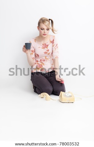 young woman with lollipop, coffee and telephone