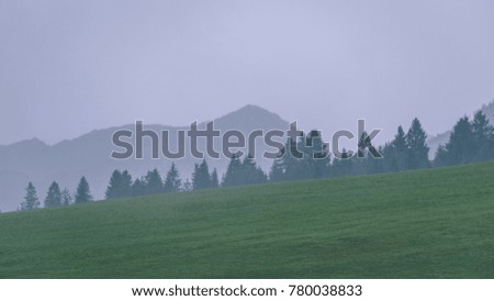 western carpathian mountain tops in  autumn covered in mist or clouds. panoramic view from a distance - vintage film look