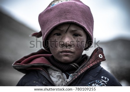 Innocent Rika - The kid of a nomad living a really hard but simple life in outdoors. Portrait of a kid in Ladakh. Facial expression of a boy in Ladakh. Hardship of kids in India. Shot in Ladakh, India
