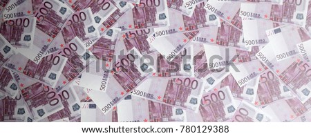 Money background consisting of purple five hundred Euro bills spread across the screen. Symbolic texture photo of wealth