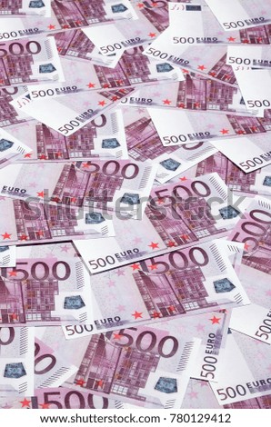Money background consisting of purple five hundred Euro bills spread across the screen. Symbolic texture photo of wealth