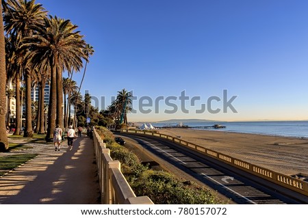 View of Santa Monica beach, California incline and Pacific Coast highway, and people walking in Palisades park. Royalty-Free Stock Photo #780157072
