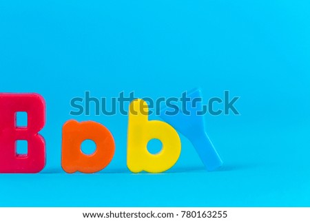 Baby multicolored letters on a blue background