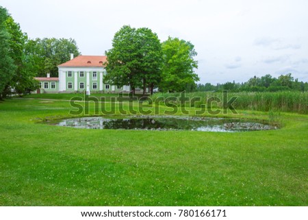 Latvia,City Aluksne, old hause and pond. Trees and green grass. Travel photo.