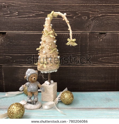 Christmas tree on a wooden background with a bear