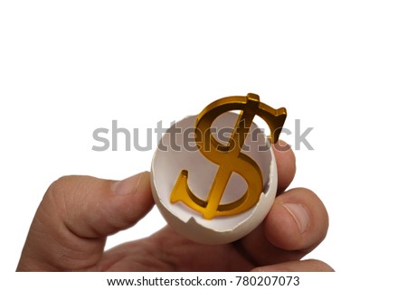 golden Dollar sign with egg. male hand hold cracked egg with dollar sign inside. gold standart