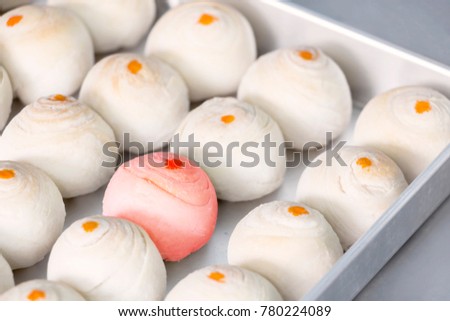Dessert Chinese pastry or mooncake for Chinese new year in baking tray on table background. Baking ingredients for homemade making  the dough  with salted egg yolk and a scented candle. 