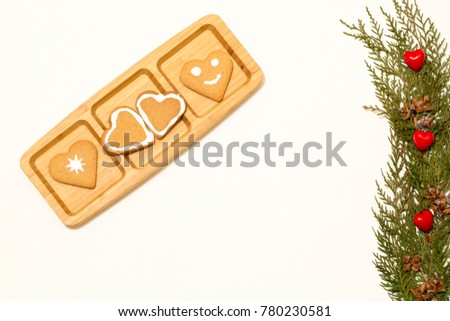 Valentines love concept: Cookies in heart shape symbolize Love decorated with green pine branches isolated on white background. Top view. Macro, close up.