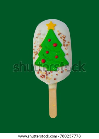 Christmas candies and ice cream decorated as Christmas trees on green background. New year and Christmas composition