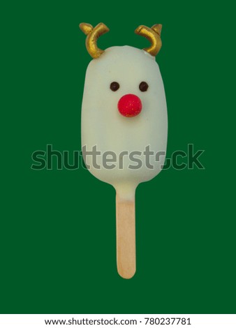 Christmas candies and ice cream decorated as reindeer on green background. New year and Christmas composition